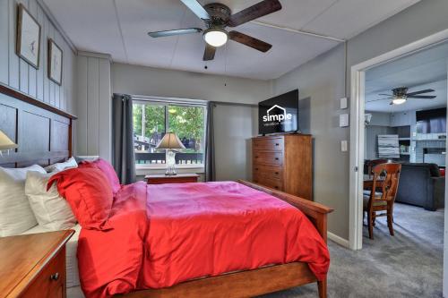 a bedroom with a bed with a red comforter at The Snowshed Steps at Mt Green - Walk-to-Lifts Ski Condo with Pools, AC, Fireplace & Shuttle! in Killington