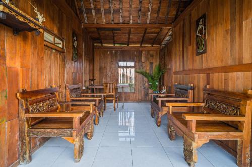 a row of wooden benches in a room at Paddy's Glamping Managed by Manara in Canggu