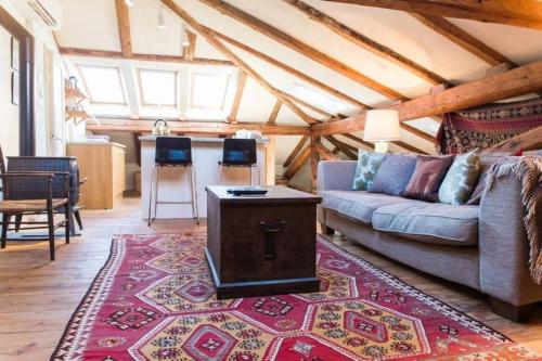 a living room with a couch and a rug at Tolmin Center Apartments Townhouse & Loft in Tolmin