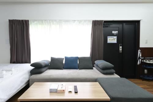 a living room with a couch and a coffee table at Shinjuku family apartment in Tokyo