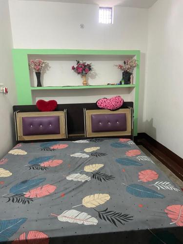 a bedroom with two beds and a bedspread with fish at Abhijeet in Rāe Bareli