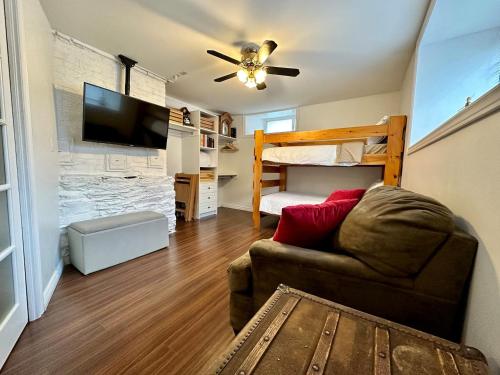 a living room with a couch and a bunk bed at Hiltz House Cellar Suite Near Halifax Ferry in Halifax