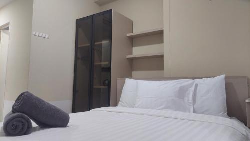 a bedroom with a bed with a tire on it at Tokyo Riverside Apartment @ PIK 2 in Tangerang