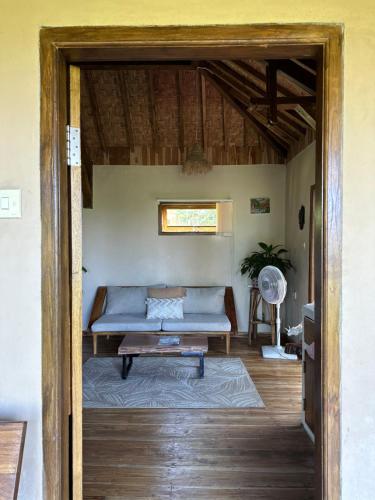 a living room with a couch and a table at Santai House in Tetebatu