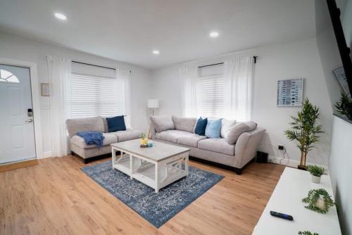 a living room with a couch and a table at Beautiful Spacious Stylish near Busch Gardens in Tampa