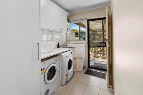a kitchen with a washer and dryer in it at Sunset Cove in Piries