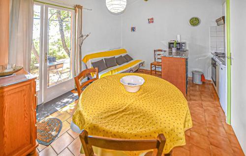 a dining room with a yellow table and a kitchen at Maison Avec Piscine in Villars