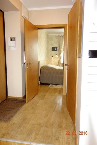 an open door to a bedroom with a bed at Riga Old Town River View with balcony in Rīga