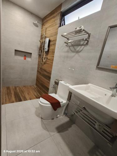 a bathroom with a toilet and a sink at Sim Vintage Villa Langkawi in Kuah