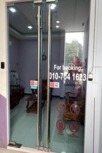 a sign on a glass door of a store at ABC Hostel in Seri Kembangan
