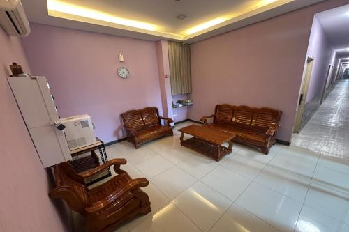 a room with chairs and a table and a refrigerator at ABC Hostel in Seri Kembangan