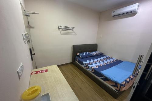 a small bedroom with a bed in a room at ABC Hostel in Seri Kembangan