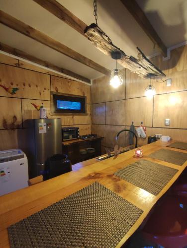 a kitchen with a wooden counter top in a room at Cabaña privada con acceso a playa in Castro