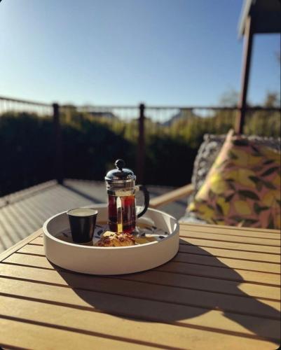 a tray with a tea pot and a cup on a table at Yarrimbah Relaxed Coastal Getaway in Capel