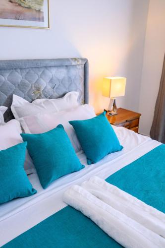 a bedroom with a bed with blue pillows at Casa Johanne Malindi staycation in Malindi