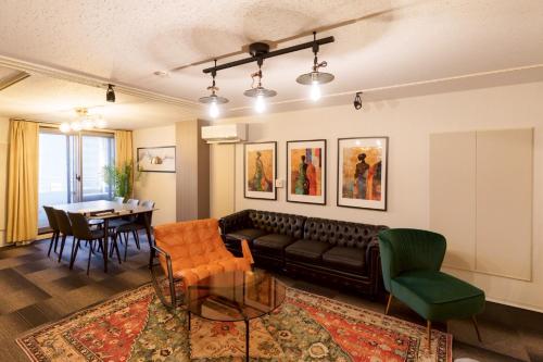 a living room with a couch and a table at Another Sky 名古屋駅前 in Nagoya