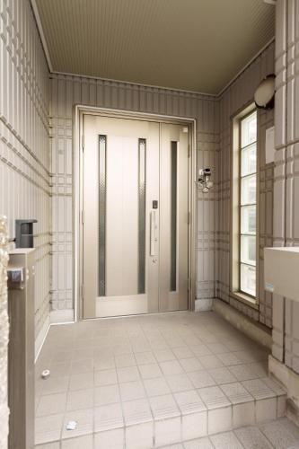 a door in a room with a tile floor at Another Sky 名古屋駅前 in Nagoya