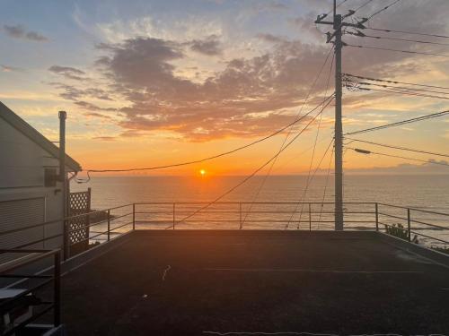 a sunset on a cruise ship in the ocean at Ｊ Studio Oarai in Hokota
