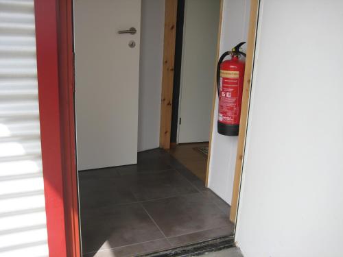 a fire hydrant is hanging on a wall in a room at Ásbrandsstadir Cottages in Vopnafjörður