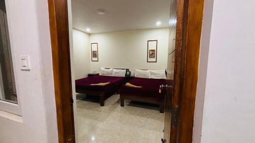 a view of a room with a bed and a mirror at Hidden doors apartment in Ooty