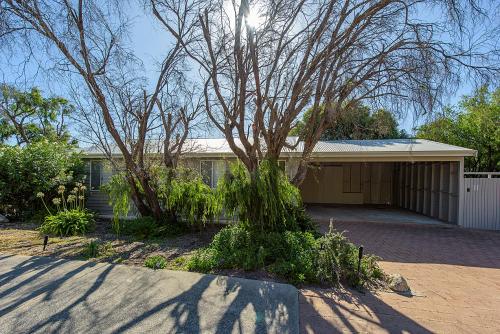 a house with a tree in front of it at Yarrimbah Relaxed Coastal Getaway in Capel