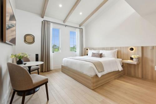 a bedroom with a bed and a desk and a window at Casa Riviera - Boutique Suites in Downtown Santa Barbara in Santa Barbara