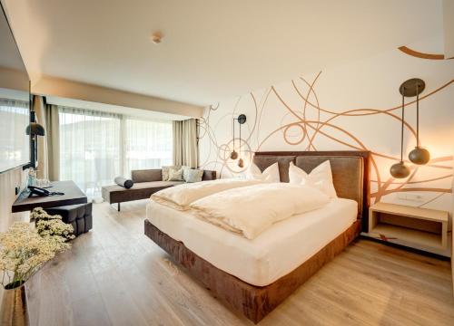 a bedroom with a large bed and a couch at Weingut Donabaum "In der Spitz" in Spitz