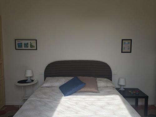 a bedroom with a bed with a blue pillow on it at Casa di Marisa in Chieti