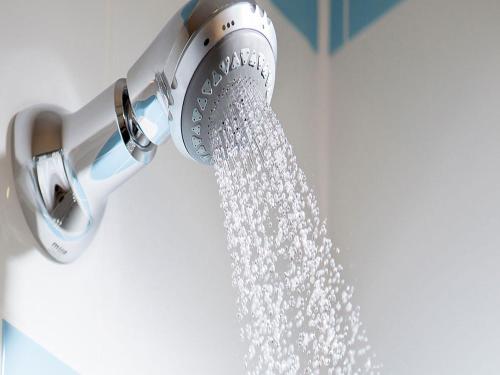 a shower head with water coming out of it at Leonardo Hotel Inverness in Inverness