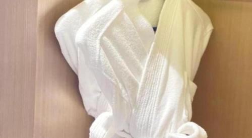 a bunch of white towels hanging on a wall at E-Cheng Hotel Yangjiang Baili Plaza in Yangjiang