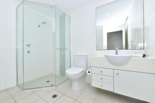 a bathroom with a toilet and a sink and a shower at Pacific Blue Unit 175 Dual Swim Up B in Salamander Bay