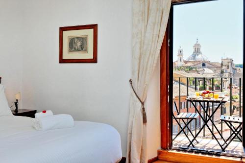 a bedroom with a bed and a window with a view at Terrazze Navona in Rome