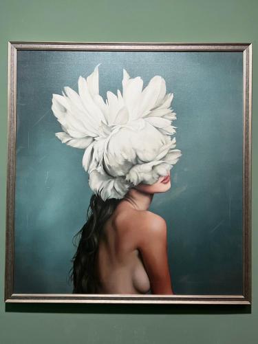 a painting of a woman with a large white hat at Poshtel 56 in Bangkok