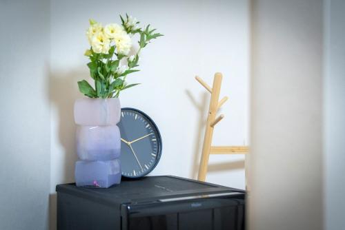 a vase of flowers sitting on top of a tv at Sumida River Temple Villa in Tokyo