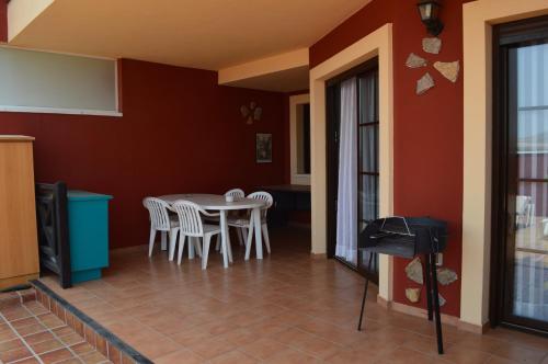 a dining room with a table and chairs at El Cotillo in El Cotillo