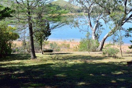 a park with trees and a lake in the background at Bonnie Dawn - Bonnie Doon in Bonnie Doon