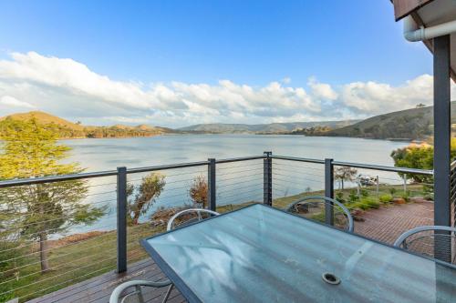 a table on a balcony with a view of a lake at Bonnie Dawn - Bonnie Doon in Bonnie Doon