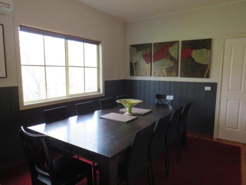 a dining room with a wooden table and chairs at Bluestones in Merrijig