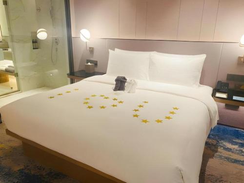 Ένα ή περισσότερα κρεβάτια σε δωμάτιο στο Onejee Hotel Shenzhen