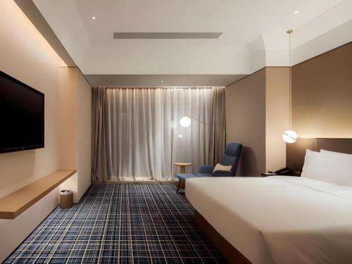 Ένα ή περισσότερα κρεβάτια σε δωμάτιο στο Onejee Hotel Shenzhen