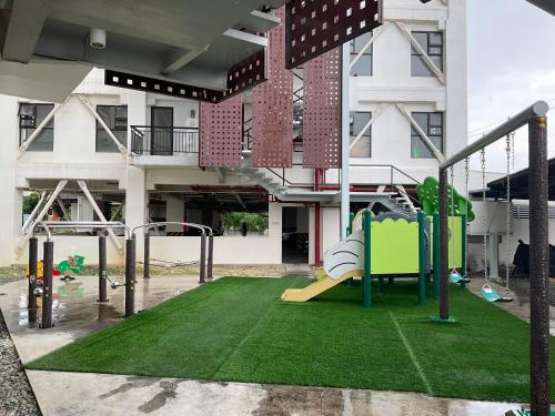 an empty playground in front of a building at Deluxe 2 Bedroom Condo Royal Oceancrest Mactan in Mactan Island