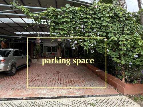 a parking garage with a sign that reads parking space at Saku Boutique Homestay in Saraphi