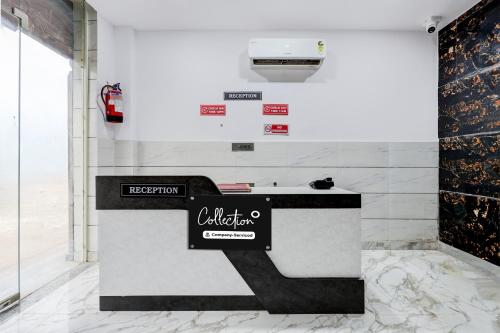 a counter with a sign on it in a room at Super Collection O Rohini Sector 21 Formerly Shelter Inn in New Delhi