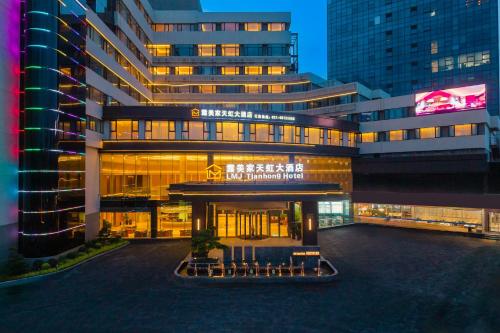 a large building with chairs in front of it at Lumijia Rainbow Hotel in Shanghai