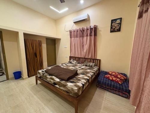 a small bedroom with a bed and a window at Golden Nest Farms 3BHK Private Pool by Homeyhuts in Venkatāpur
