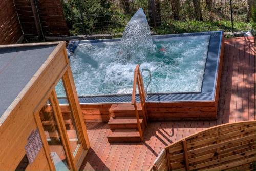 a plunge pool on a deck with a fountain at Apartament Ornak in Zakopane