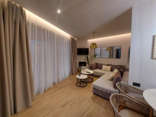 a living room with a couch and a table at Euphoria Seafront Residence in Anissaras