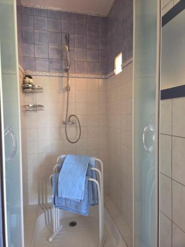a bathroom with a shower with a towel on a walk in shower at Aurelia Verdon in Angles