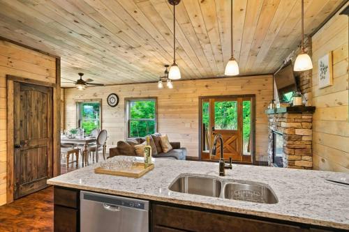 a kitchen with a sink and a living room at NEWLY BUILT Amazing View Chalet Perfect Location in Gatlinburg