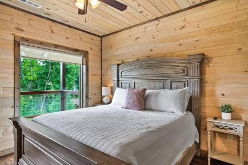 a bedroom with a large bed and a window at NEWLY BUILT Amazing View Chalet Perfect Location in Gatlinburg